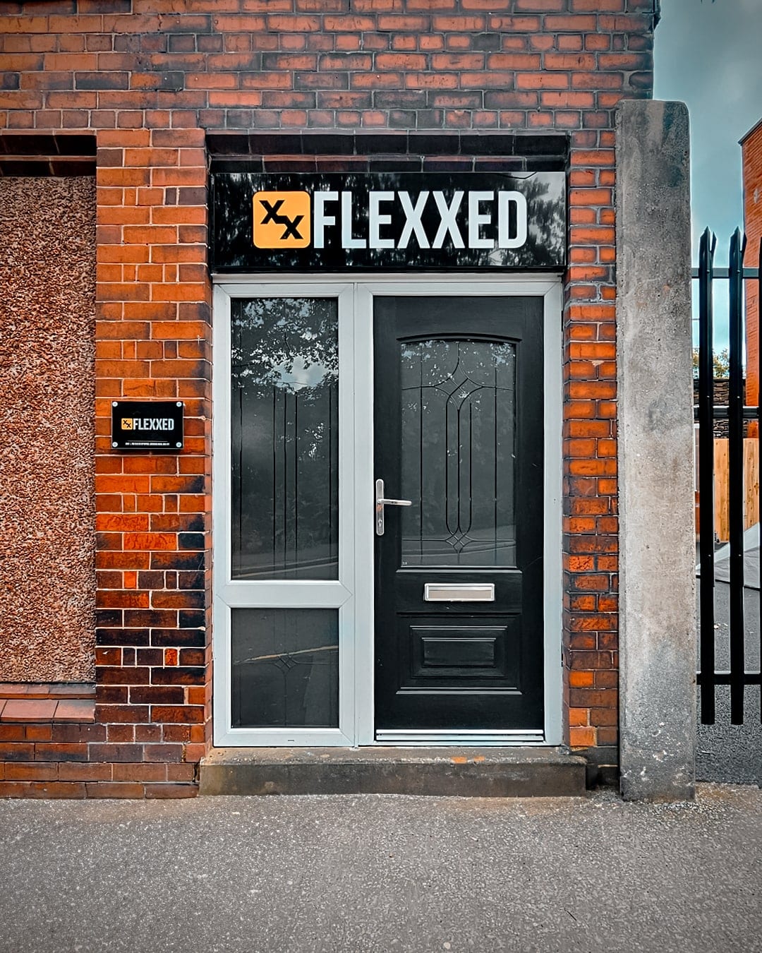 The Flexxed studio entrance with the yellow sign on Borough Road, Darwen