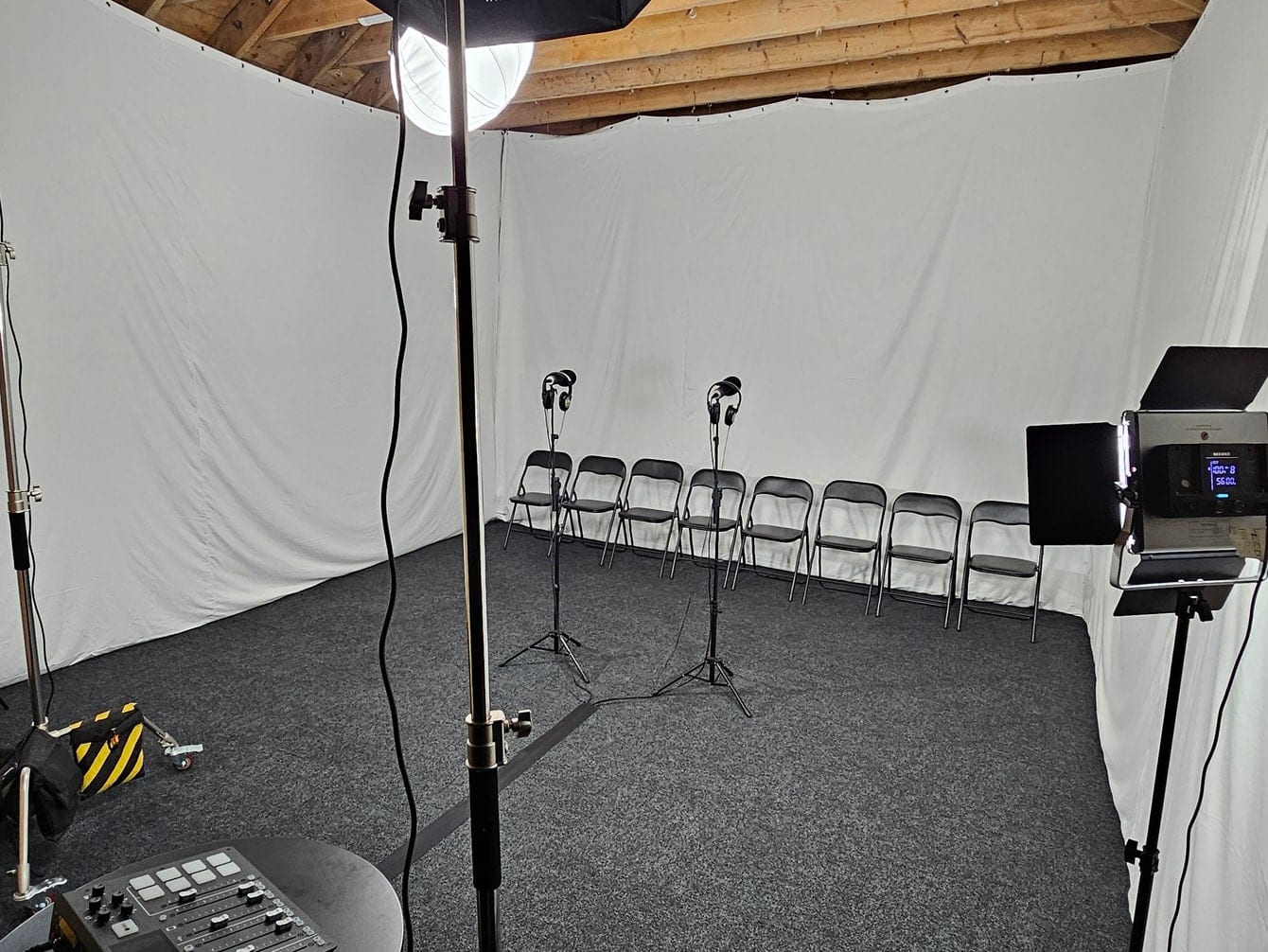 The white cyclorama lit with a row of chairs set out for a shoot