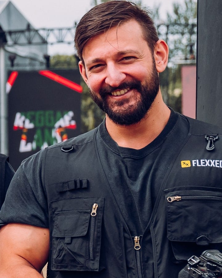 Arman at Reggae Land in a Flexxed vest, mid-laugh