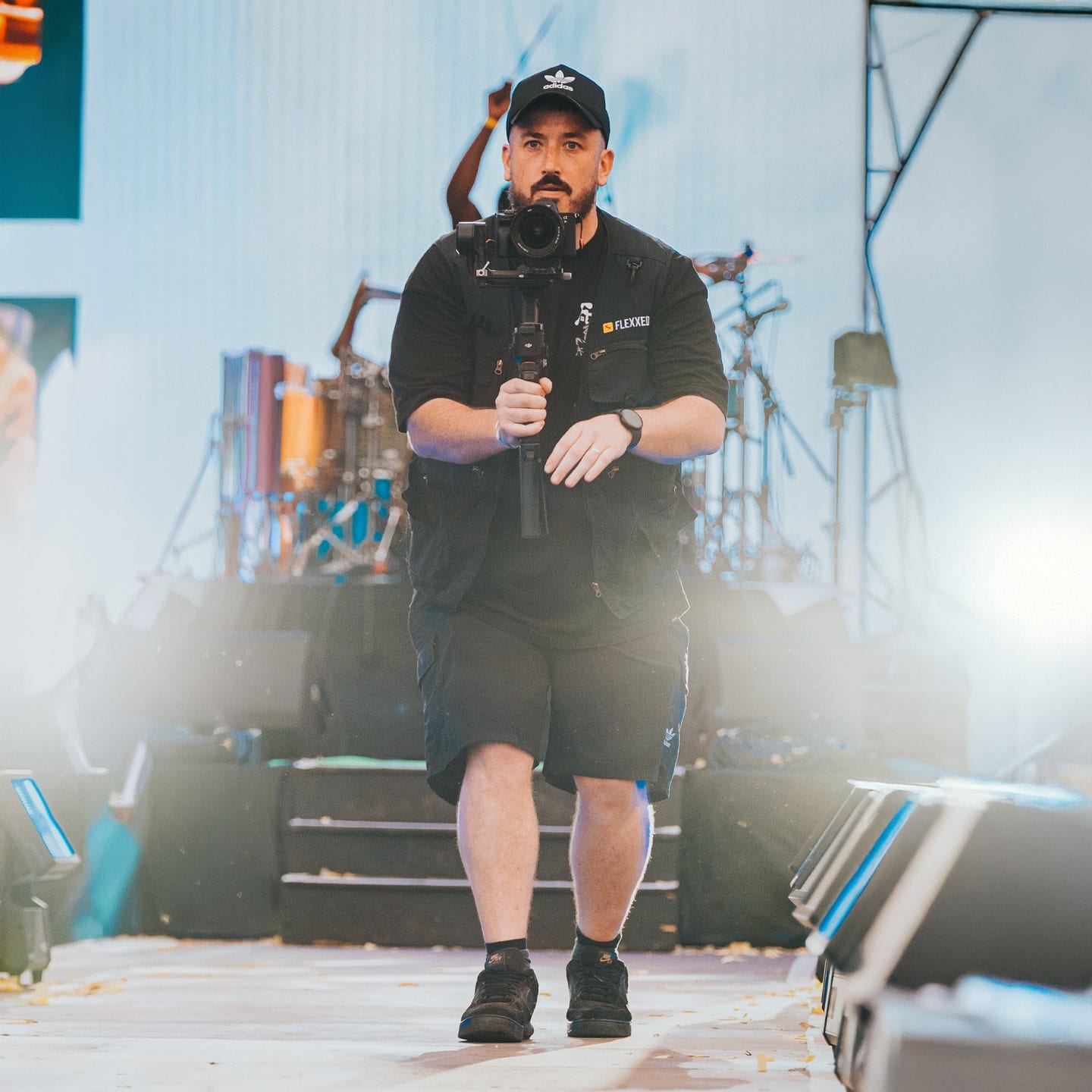 Camera operator working in stage smoke during a live set